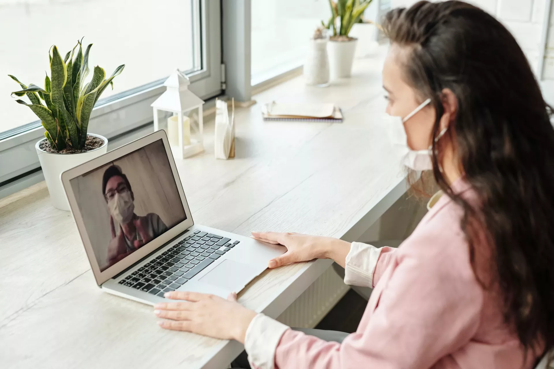 Woman having a telemedicine session with a doctor on her laptop