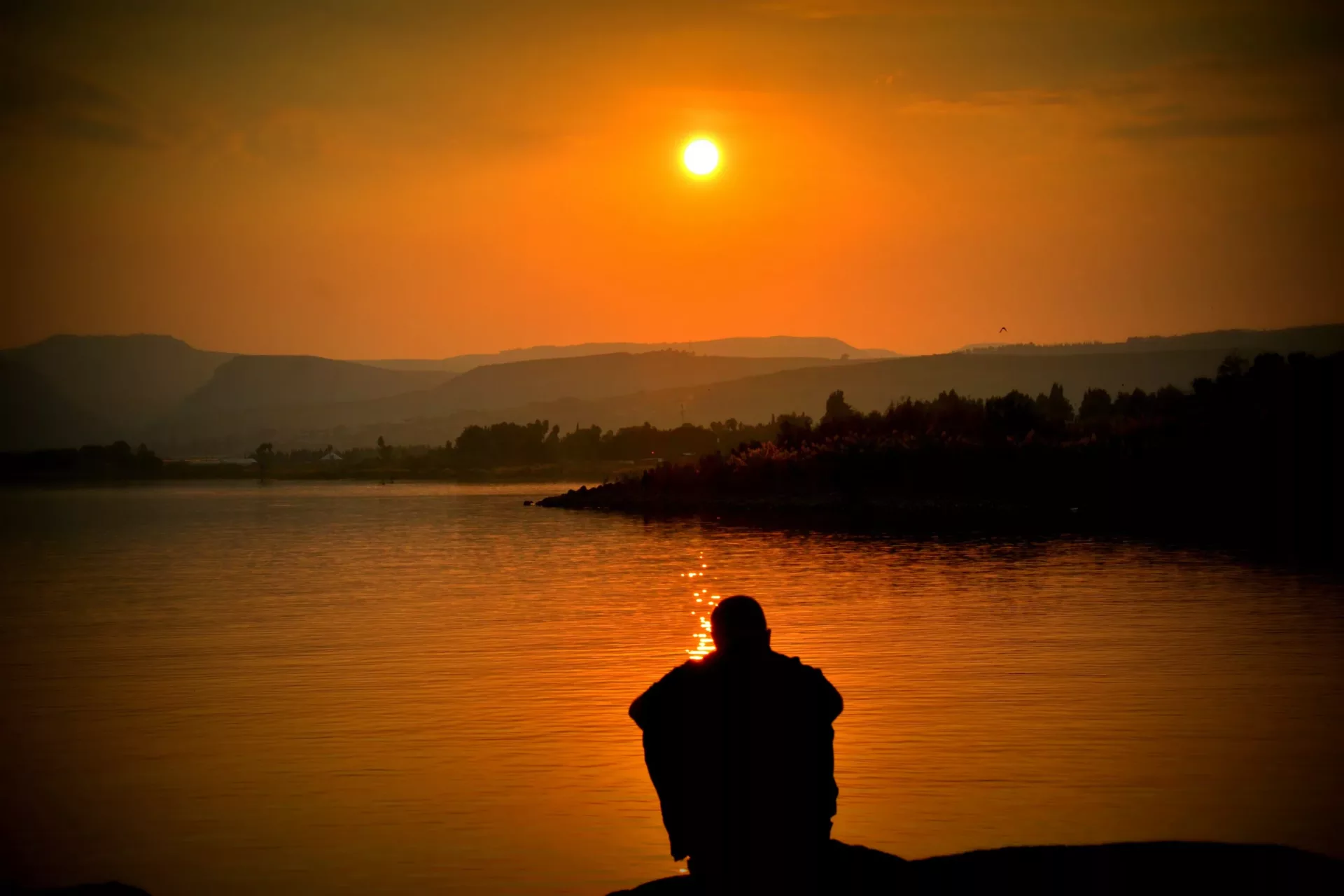 Guy sitting while watching the sun set