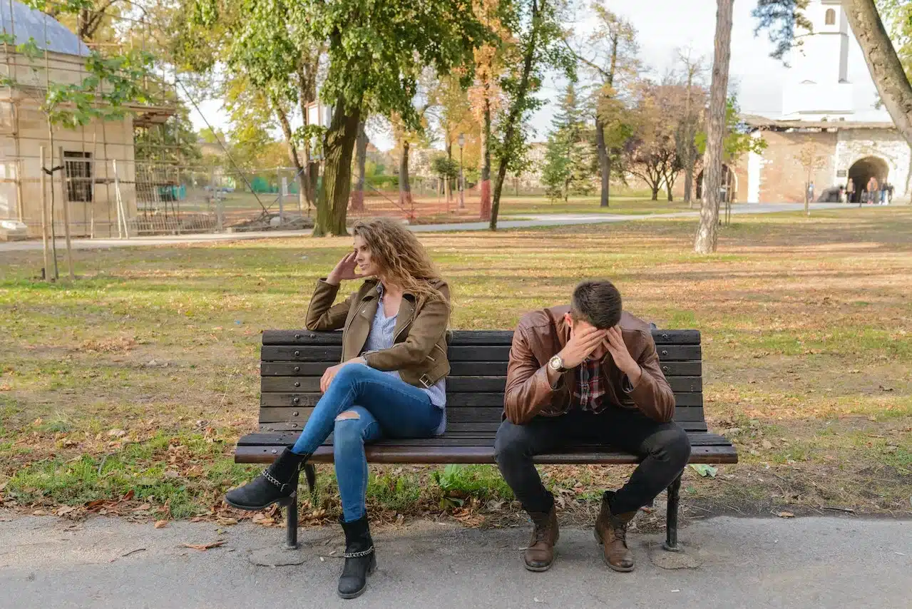 Woman And Man Sitting on Bench and arguing