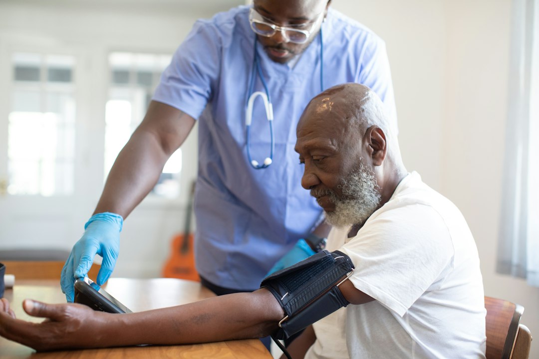 clinician checking a patient's vital signs